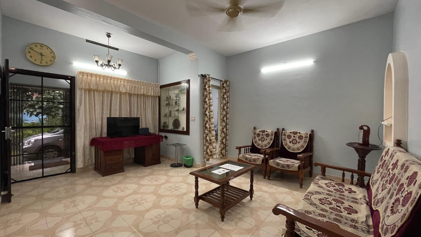 Bright living room with sofa set, coffee table and TV